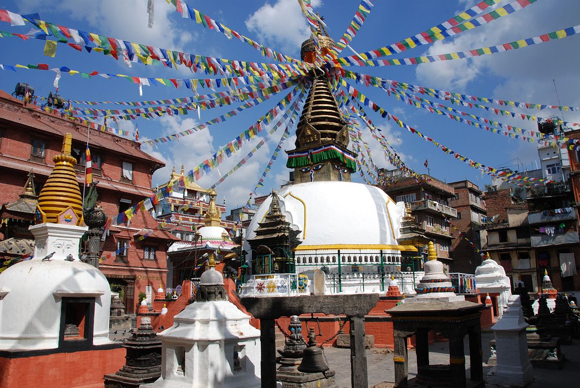 Kathmandu 04 02 Kathesimbhu Stupa On the walk from Thamel to Kathmandu Durbar Square I stopped at the Kathesimbhu Stupa, a small copy dating from around 1650 of the great Swayambhunath complex. Just as at Swayambhunath, there is a two-storey pagoda to Harti, the goddess of smallpox, right behind the main stupa. The entrance is flanked by metal lions atop red ochre concrete pillars. Various statues and smaller chaityas (small stupas) stand around the temple, including a fine standing Avalokiteshvara statue enclosed in a glass case and protective metal cage in the northeast corner. Avalokiteshvara carries a lotus flower in his left hand, and the Dhyani Buddha Amitabha is seen in the centre of his crown.